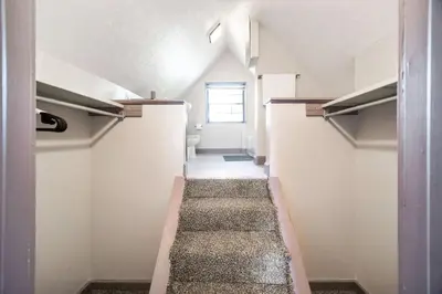 a long hallway with stairs in an empty room at Bamboo Retreat- Private Parking -New Reno -Central in Columbus