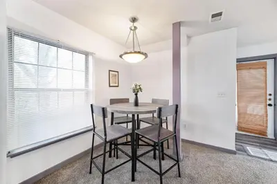 a dining room with a table and chairs and a window at Bamboo Retreat- Private Parking -New Reno -Central in Columbus