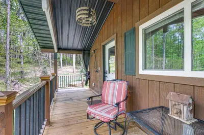 a porch with a rocking chair on a deck at Hocking Hills Social Distance Cabin with Hot Tub in Laurelville