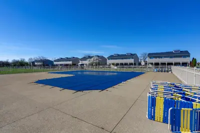 a large swimming pool withools in front of a building at Boat Slip and Pool Access Oak Harbor Haven! in Oak Harbor