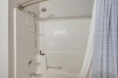a shower in a bathroom with a shower curtain at Boat Slip and Pool Access Oak Harbor Haven! in Oak Harbor
