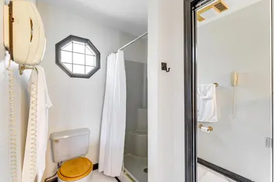 a bathroom with a toilet and a shower at Bike, Fish, Golf and More Stately Tudor in Mogadore in Uniontown
