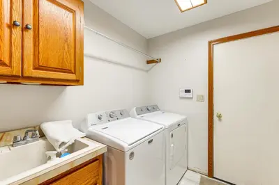 a kitchen with a washing machine and a sink at Bike, Fish, Golf and More Stately Tudor in Mogadore in Uniontown