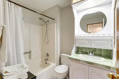 a bathroom with a sink and a toilet and a mirror at Bike, Fish, Golf and More Stately Tudor in Mogadore in Uniontown