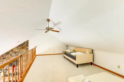 a living room with a ceiling fan and a crib at Bike, Fish, Golf and More Stately Tudor in Mogadore in Uniontown