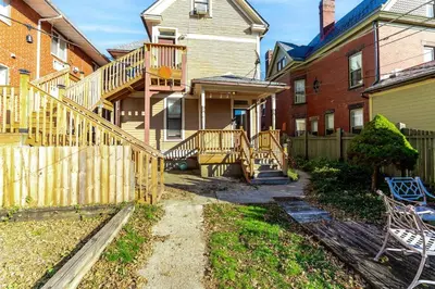a house with a wooden staircase in a yard at Shine Retreat - Private parking - Newly Reno - OSU in Columbus