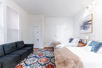 a living room with a bed and a couch at Shine Retreat - Private parking - Newly Reno - OSU in Columbus