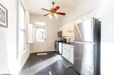 a kitchen with a refrigerator and a ceiling fan at Shine Retreat - Private parking - Newly Reno - OSU in Columbus