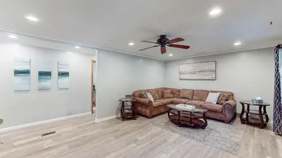 a living room with a couch and a ceiling fan at Sideline Sanctuary: Cozy Nights, Game Day Lights in Canton