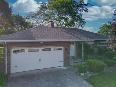 a garage with a white garage door on a house at Sideline Sanctuary: Cozy Nights, Game Day Lights in Canton