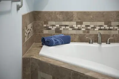 a bathroom sink with a blue towel sitting on it at The Blitz House-Where Legends Unwind in Canton