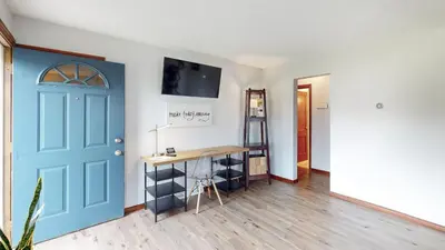 a room with a blue door and a desk at Snap, Set, Stay-Game Day Comfort Near It All in Canton