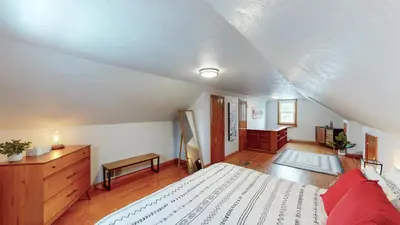 a bedroom with a white bed and a dresser at Snap, Set, Stay-Game Day Comfort Near It All in Canton