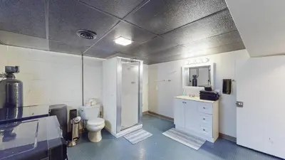 a bathroom with a toilet and a sink and a mirror at Snap, Set, Stay-Game Day Comfort Near It All in Canton