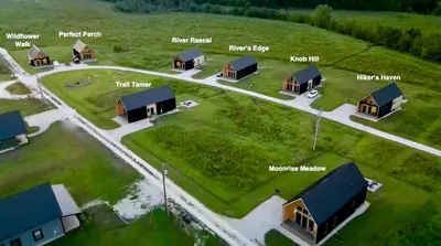 an aerial view of a group of cottages at Three Suns Full Rental | 8 Cabins | Views | River in Stanton