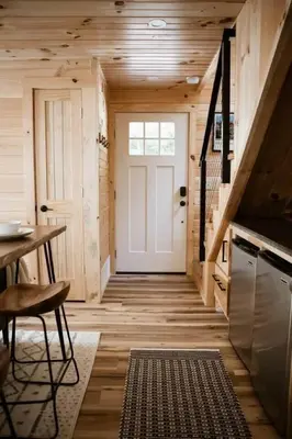 a hallway with a white door and a table and chairs at Middlefork Ridge Entire Property in Laurelville
