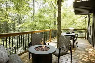 a deck with chairs and a table with a fire pit at Middlefork Ridge Entire Property in Laurelville