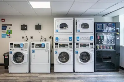 four washers and dryers in a laundry room at Modern Stay Comfort-Free Parking in Cincinnati
