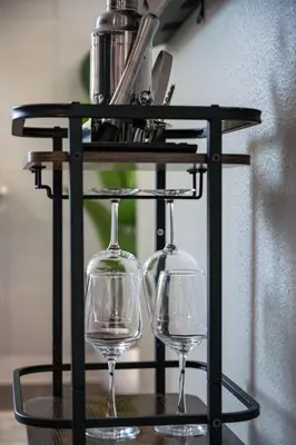 two wine glasses sitting on a glass table at Modern Stay Comfort-Free Parking in Cincinnati