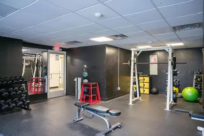a gym with dumbbells and weights in a room at Modern Stay Comfort-Free Parking in Cincinnati