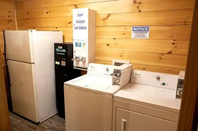 a kitchen with two refrigerators and a refrigerator at Sweet Tree Cabin with Grill Overlooking Tappan Lake in Ohio in Deersville