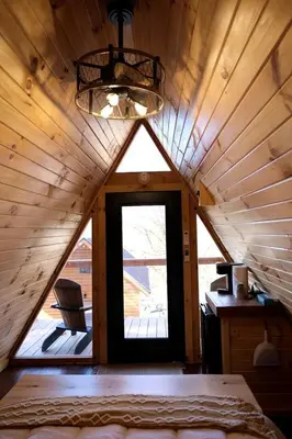 a room with a large window in a cabin at Lovely Rural Cabin Nestled Among Nature by Tappan Lake in Ohio in Deersville