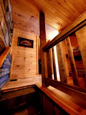 an inside view of a wooden room in a cabin at Renovated Cottage with Spa Surrounded by Beautiful Hiking Trails by Tappan Lake in Ohio in Deersville