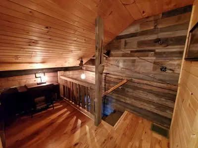 an overhead view of a room with a wooden wall at Renovated Cottage with Spa Surrounded by Beautiful Hiking Trails by Tappan Lake in Ohio in Deersville