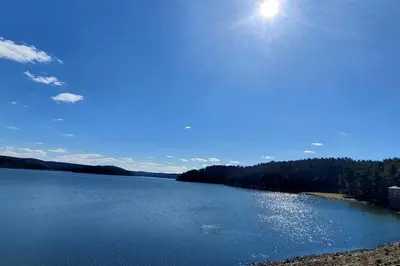a large body of water with the sun in the sky at Renovated Cottage with Spa Surrounded by Beautiful Hiking Trails by Tappan Lake in Ohio in Deersville