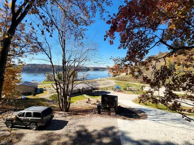 a suv parked in a parking lot next to a lake at Lofted Cabin Wonderful for Outdoor Adventures near Tappan Lake in Ohio in Deersville