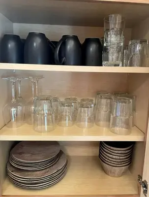a wooden shelf with glasses and plates on it at Luminous Cabin near Tappan Lake with Hot-Tub, BBQ and Deck in Ohio in Deersville