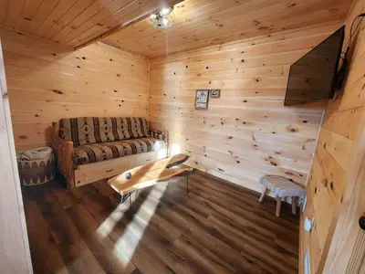 an overhead view of a log cabin with a couch at Luminous Cabin near Tappan Lake with Hot-Tub, BBQ and Deck in Ohio in Deersville
