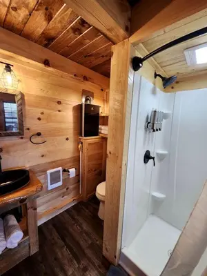 a bathroom with a toilet and a shower in a cabin at Wooden Chic Cabin Fully Stocked near Tappan Lake in Ohio in Deersville