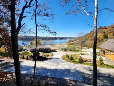 a view of a lake from the woods at Wooden Chic Cabin Fully Stocked near Tappan Lake in Ohio in Deersville