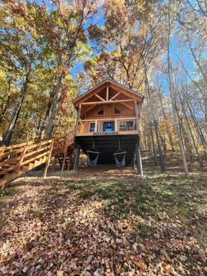 a tree house in the middle of a forest at Gorgeous Cabin Great for Family Getaways by Tappan Lake in Ohio in Deersville