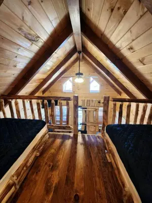 a room with two beds in a log cabin at Gorgeous Cabin Great for Family Getaways by Tappan Lake in Ohio in Deersville