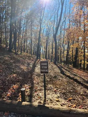 a sign in the middle of a forest at Gorgeous Cabin Great for Family Getaways by Tappan Lake in Ohio in Deersville