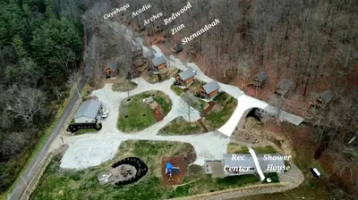 an aerial view of a house with a truck parked in the yard at Romantic A-frame Cabin Ideal for Two by Tappan Lake in Ohio in Deersville