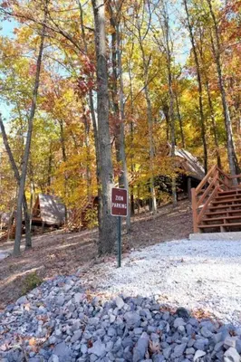 a sign in the middle of a park with a tree at Romantic A-frame Cabin Ideal for Two by Tappan Lake in Ohio in Deersville