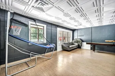 a gym with a basketball hoop in a room at Cozy Secluded Cabin with Games and Hot-tub in Sarahsville, Ohio