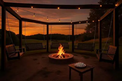 a fire pit with two benches and a table with a fire at Cozy Secluded Cabin with Games and Hot-tub in Sarahsville, Ohio