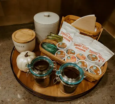 a tray with muffins and other items on a table at Cozy Secluded Cabin with Games and Hot-tub in Sarahsville, Ohio