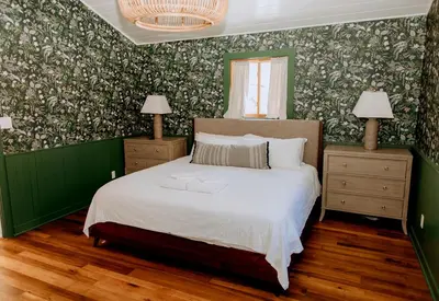 a bedroom with a bed with green and white wallpaper at 16 Guests | Ponds | Hot Tub | Game Room | Trails in Sarahsville