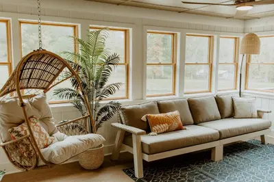 a living room with a couch and a swing at 16 Guests | Ponds | Hot Tub | Game Room | Trails in Sarahsville