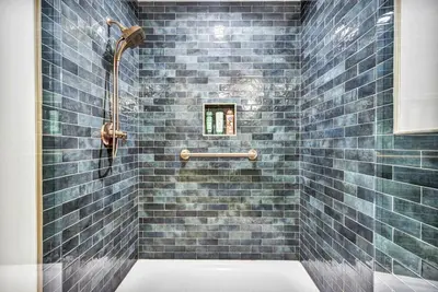 a bathroom with a blue tiled shower with a toilet at Exquisite Cabin with Amazing Interior and Exterior in Sarahsville, Ohio