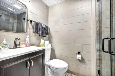 a bathroom with a toilet and a sink and a shower at Exquisite Cabin with Amazing Interior and Exterior in Sarahsville, Ohio