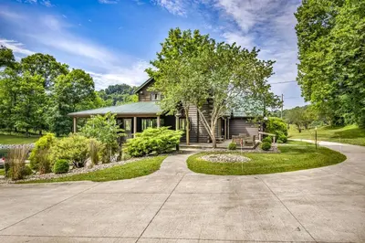 a house with a driveway in front of it at Exquisite Cabin with Amazing Interior and Exterior in Sarahsville, Ohio