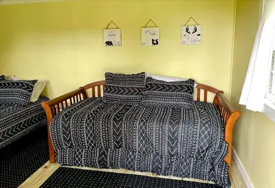 a bedroom with two beds in a room at Charming Cabin Surrounded by Woods and Fields in Oberlin, Ohio in Oberlin