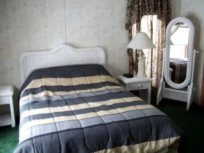 a bedroom with a bed and a mirror at Spacious Vacation Cottage Rental near the Waterfront in Beautiful Put-in-Bay, Ohio in Put-in-Bay