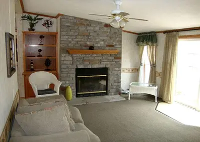 a living room with a couch and a fireplace at Spacious Vacation Cottage Rental near the Waterfront in Beautiful Put-in-Bay, Ohio in Put-in-Bay